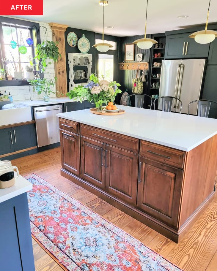 Kitchen island with wooden cabinets and white surface top after renovation