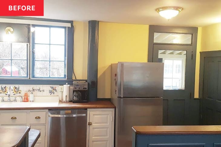 Yellow and green kitchen with white cabinets and wooden countertops before renovation.