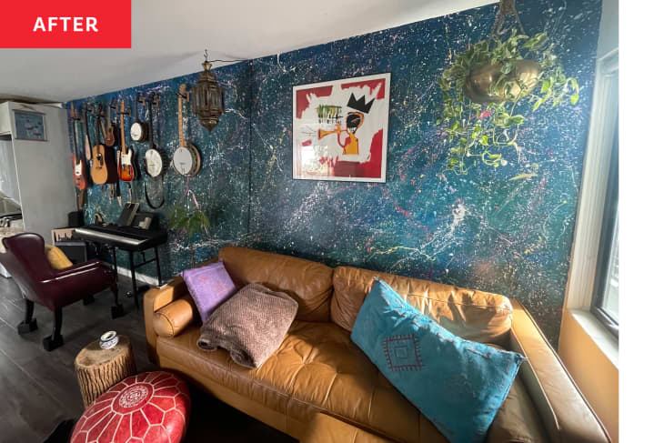 Living room after one blue/green wall has been covered in splatter paint