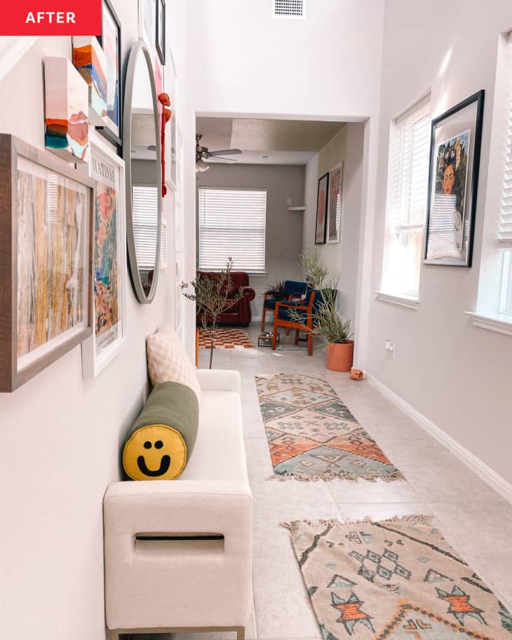 After: Hallway with vintage runner rugs, bench, and gallery wall on the lefthand side