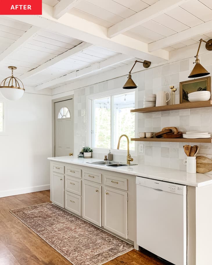 Neutral colored kitchen with open shelving after renovation.