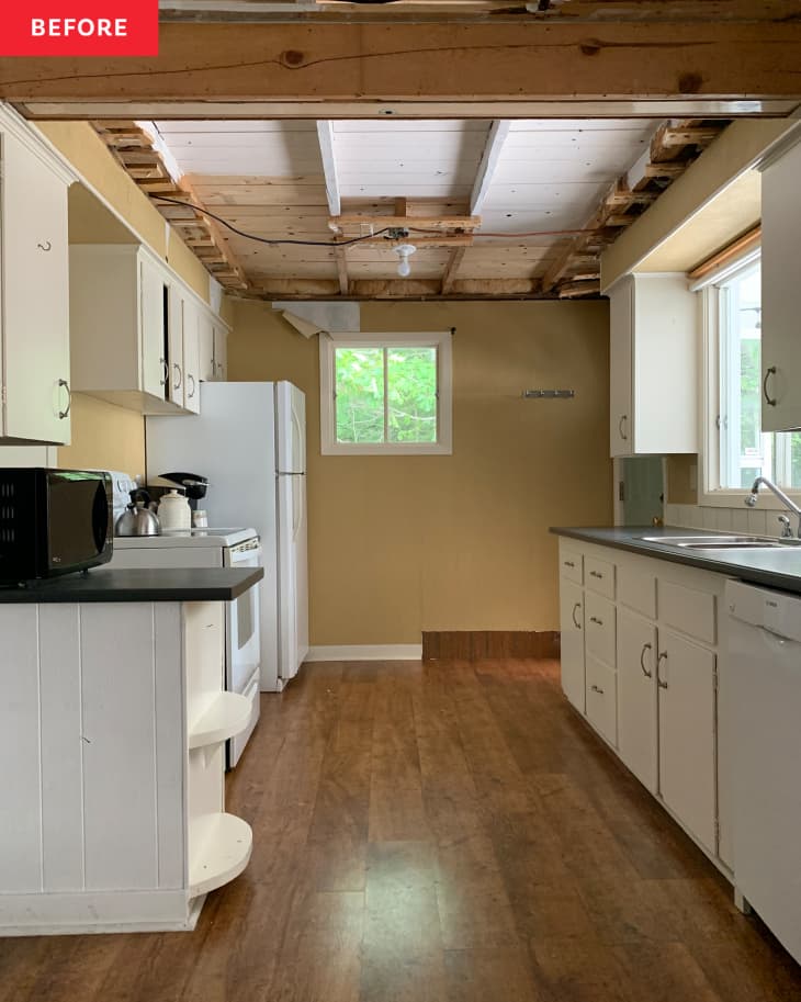 Kitchen with open beamed ceiling before renovation.