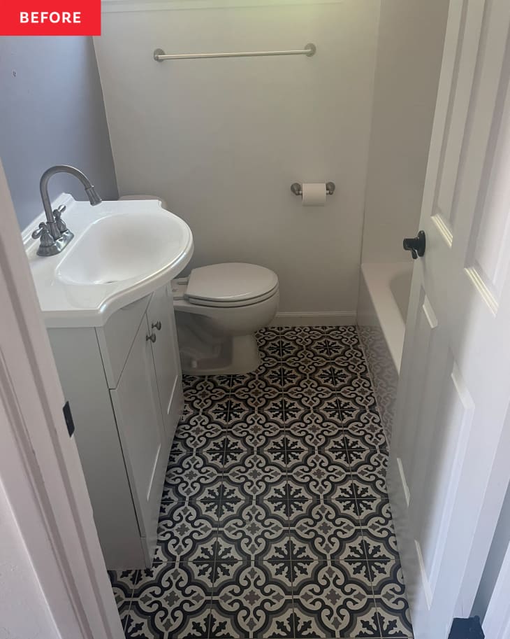 Before: Bathroom with black and tan patterned floor tile and white fixtures