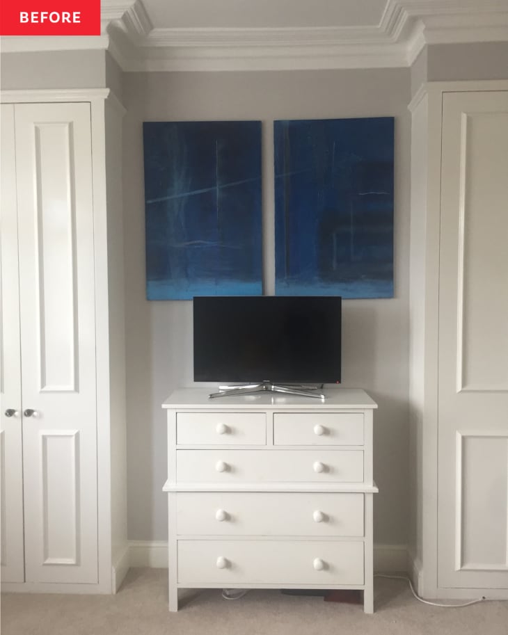 Detail of bedroom before makeover. white dresser with tv on it in between 2 tall white cabinets. Blue diptych artwork over the tv