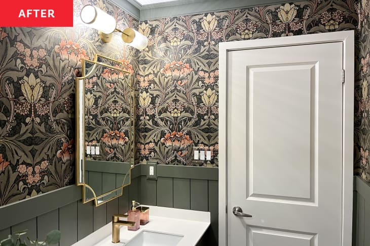 Bathroom after renovation/makeover/remodel. Patterned wallpaper walls, sage green wainscoting/trim, gold trim mirror, gold light fixture and sink hardware