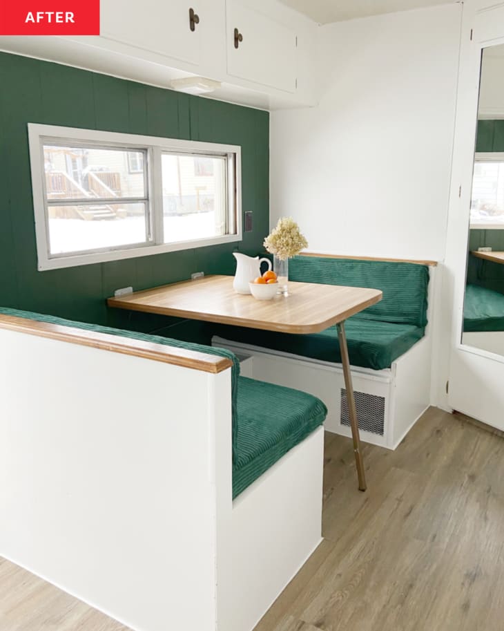 Green and white dining area in camper after renovation.