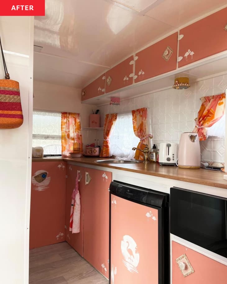 Inside of caravan/camper after renovation: coral and white paint, lot's of pops of pink, orange, fabric curtains