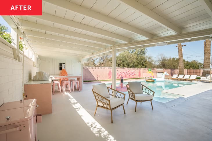 Pink painted backyard with large outdoor kitchen/barbecue area  and in ground pool.
