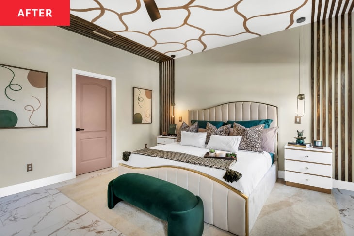 Newly remodeled bedroom with gold and white wavy ceiling motif and upholstered cream colored bed frame.