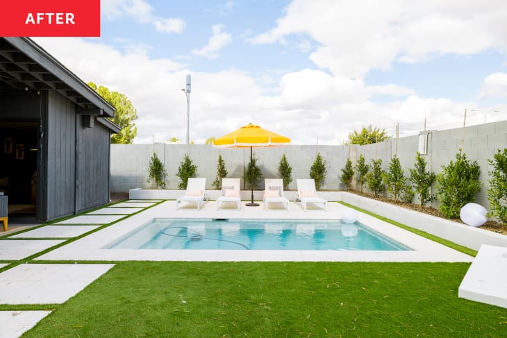 Pool with lounge seating and yellow umbrella in newly renovated backyard.