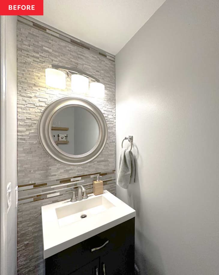 bathroom before makeover: gray walls, gray tile, brushed stainless steel hardware finishes