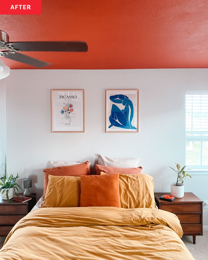 After: Bed with two mid-century side tables in room with orange ceiling