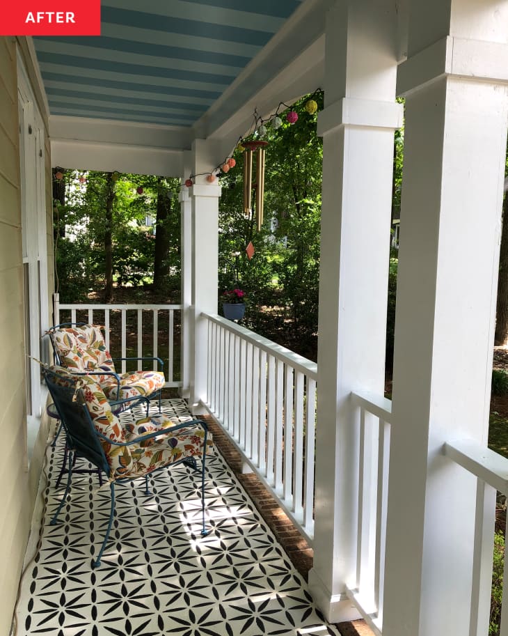 Seating area of newly renovated porch with monotone striped painted ceiling and black and white graphic flooring.