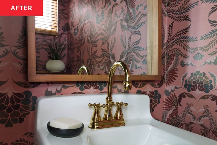 After: a white bathroom sink with a gold faucet next to a pink floral wallpapered wall