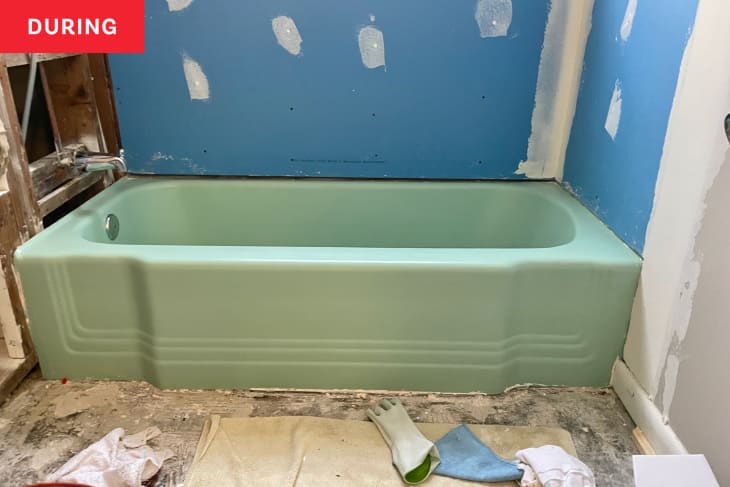 Green tub in bathroom during renovations.