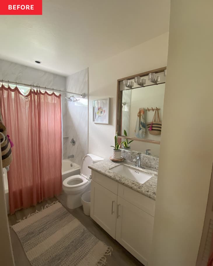White bathroom with pink shower curtain before renovation.
