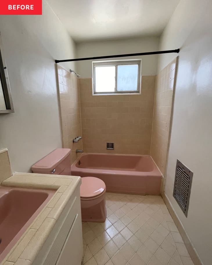 White bathroom with pink features and neutral colored tiles.