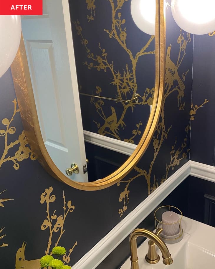 Bathroom vanity with gold mirror after powder room renovation.