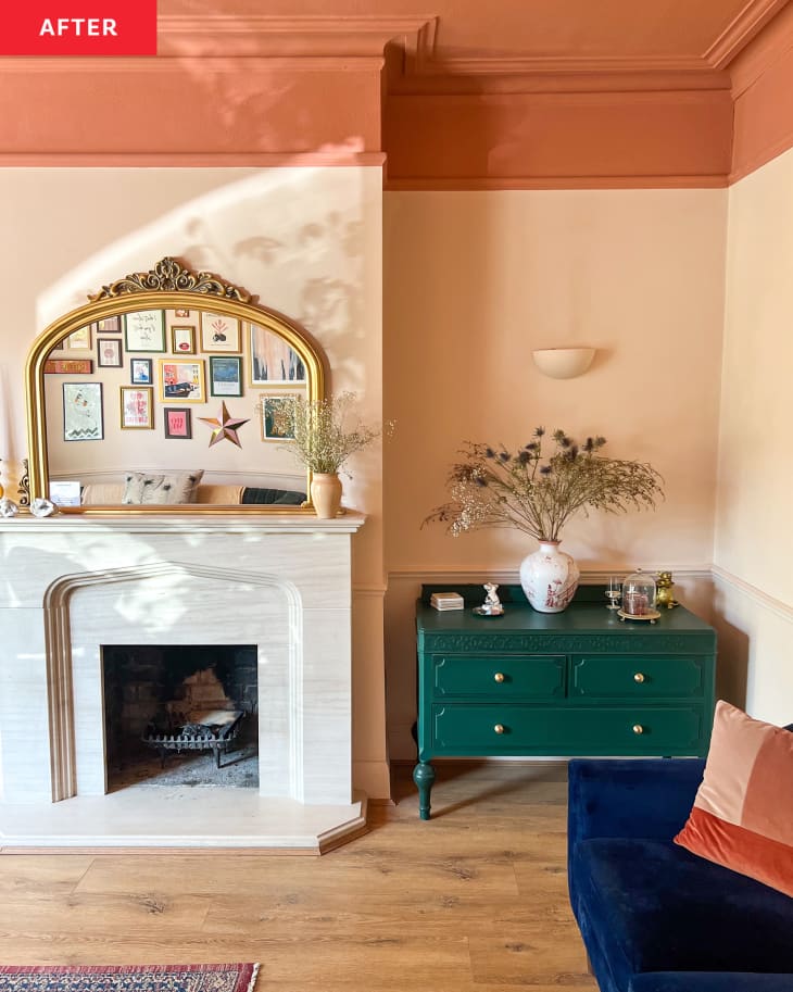 Brightly painted peach and rust colored living room with green painted dresser in corner and newly installed wood flooring.