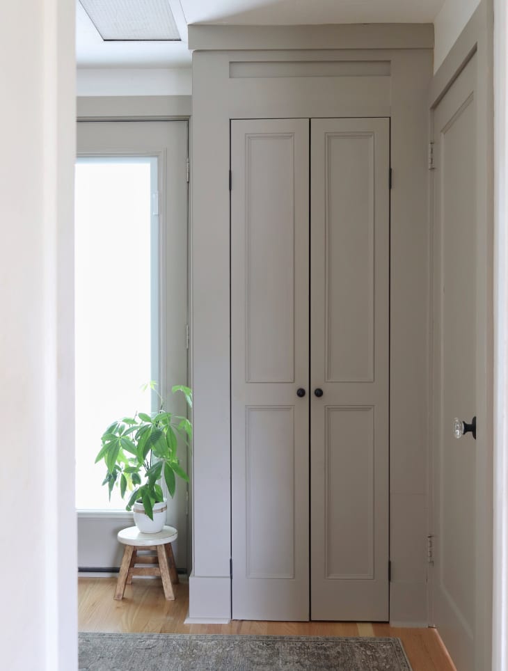 Traditional paneled closet doors painted gray viewed from front
