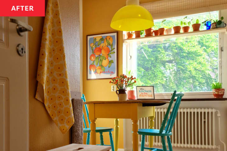 yellow walls, teal wood chairs, yellow wood table for two, wood stool, plant shelf hanging in window, white radiator, yellow round lighting fixture, floral art, yellow daisy tea towel, flowers in pitcher