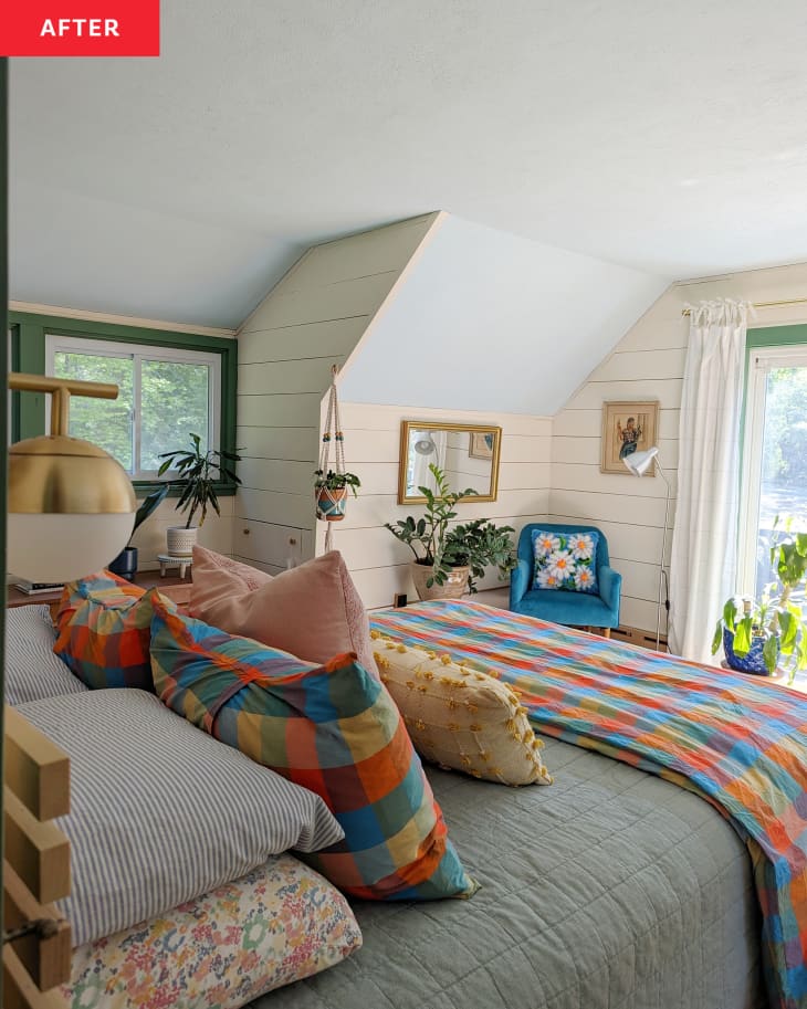 不atly made bed in bedroom with wood paneled walls painted a neutral color after renovation.