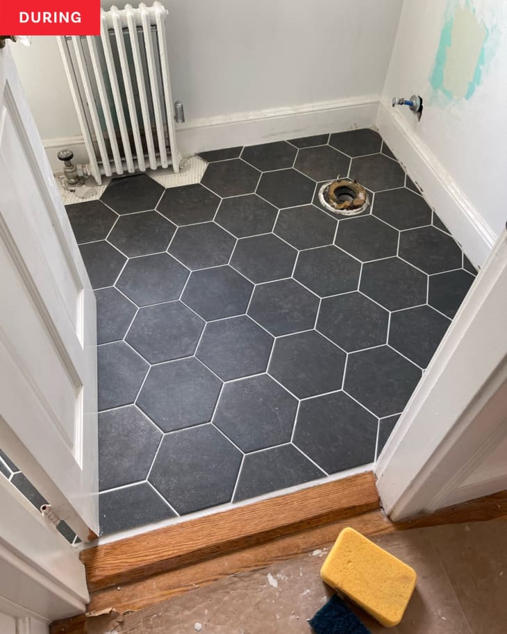 Bathroom during makeover: new hexagonal dark gray tiles added