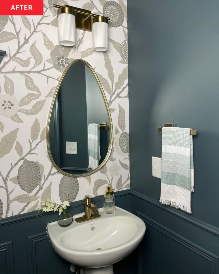 After: a teardrop shaped mirror on a floral accent wall above a bathroom sink