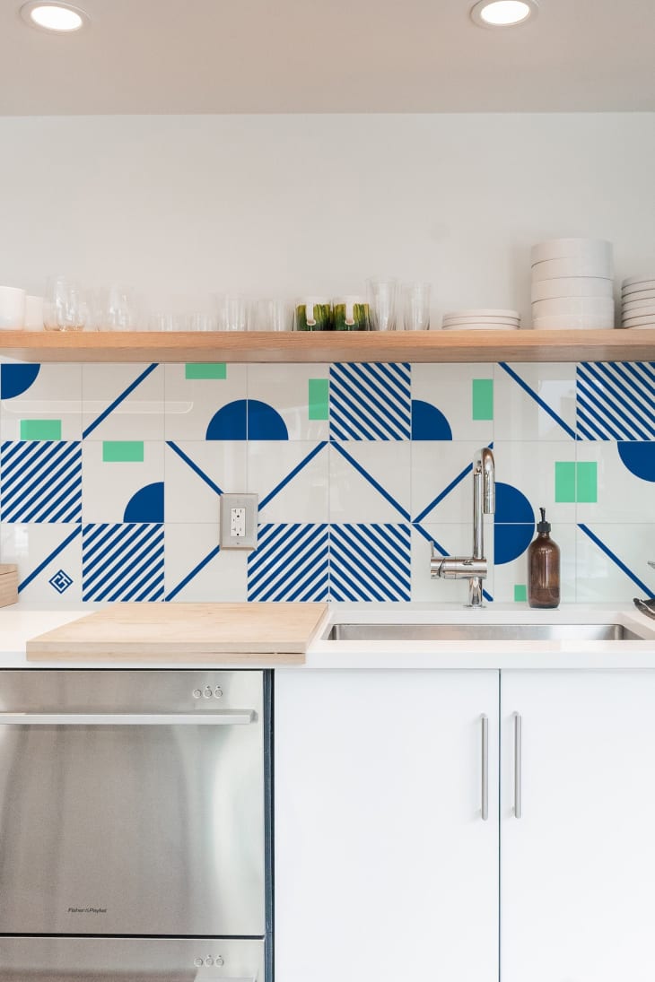 Blue, white, and green tiles on a kitchen wall