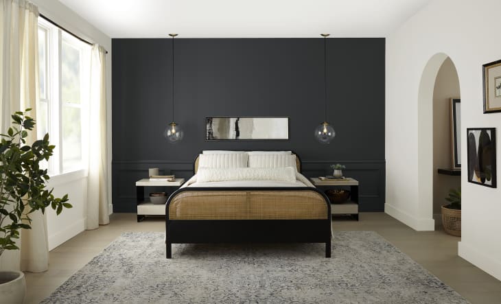 Bedroom with accent wall behind the bed featuring Behr's color of the year, Cracked Pepper