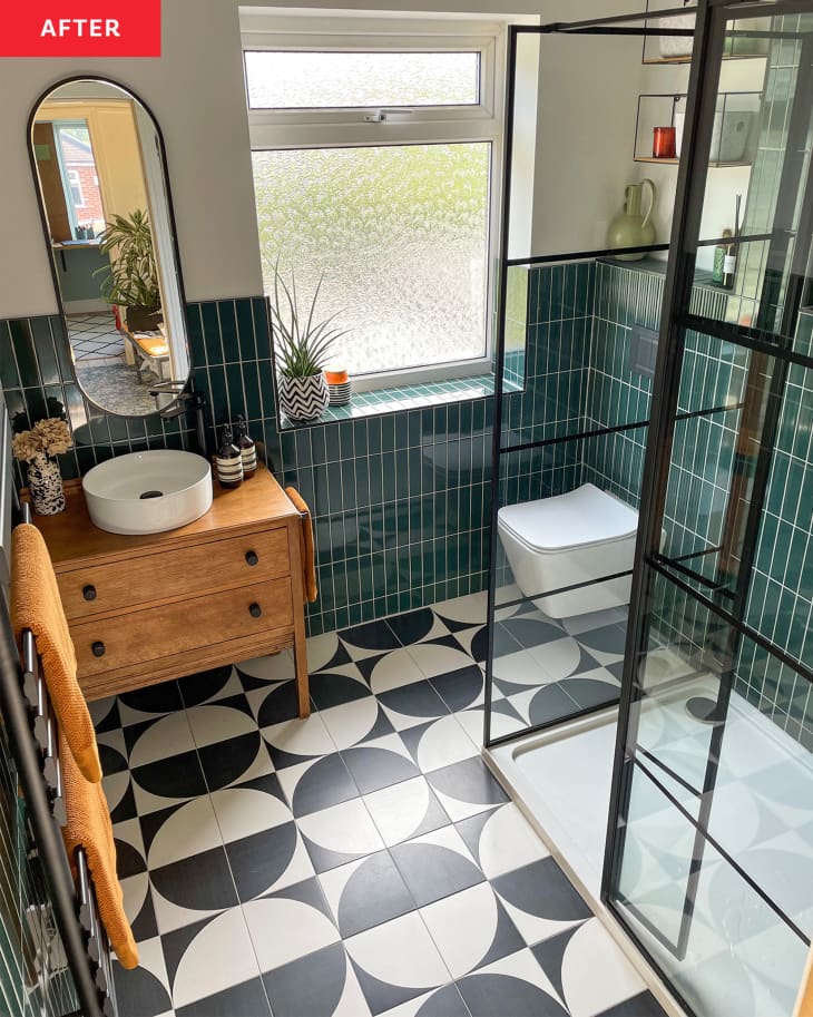 A patterned tile floor in a green bathroom.