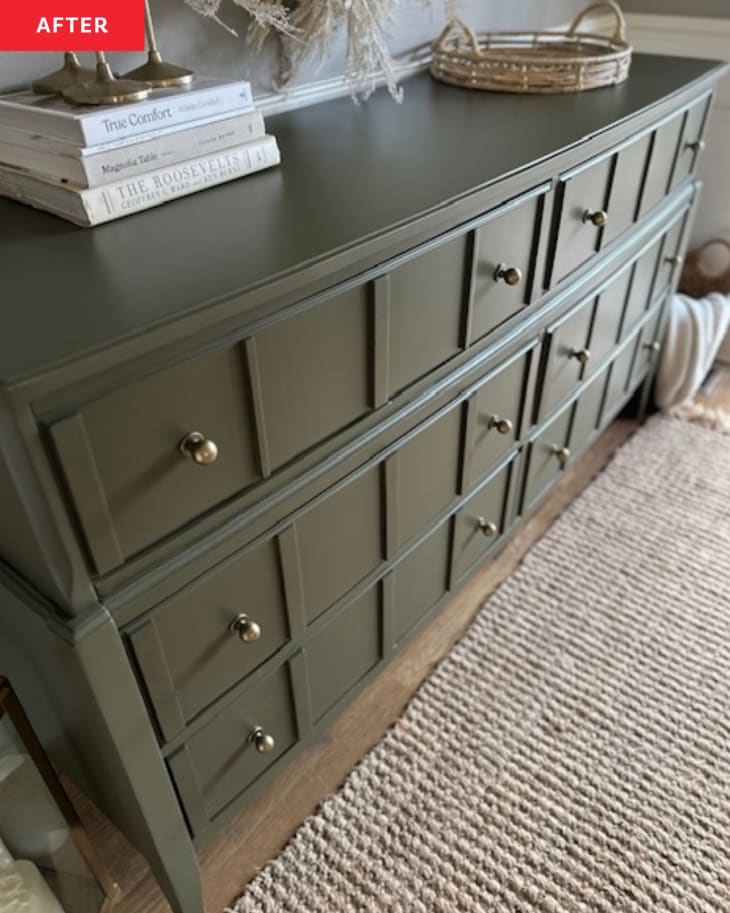 green dresser with gold hardware, stack of books, gold candlesticks, woven basket, beige textured rug