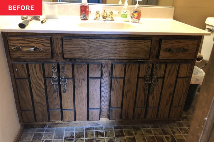 small square brown tile floor, old wood panel vanity, white counter top