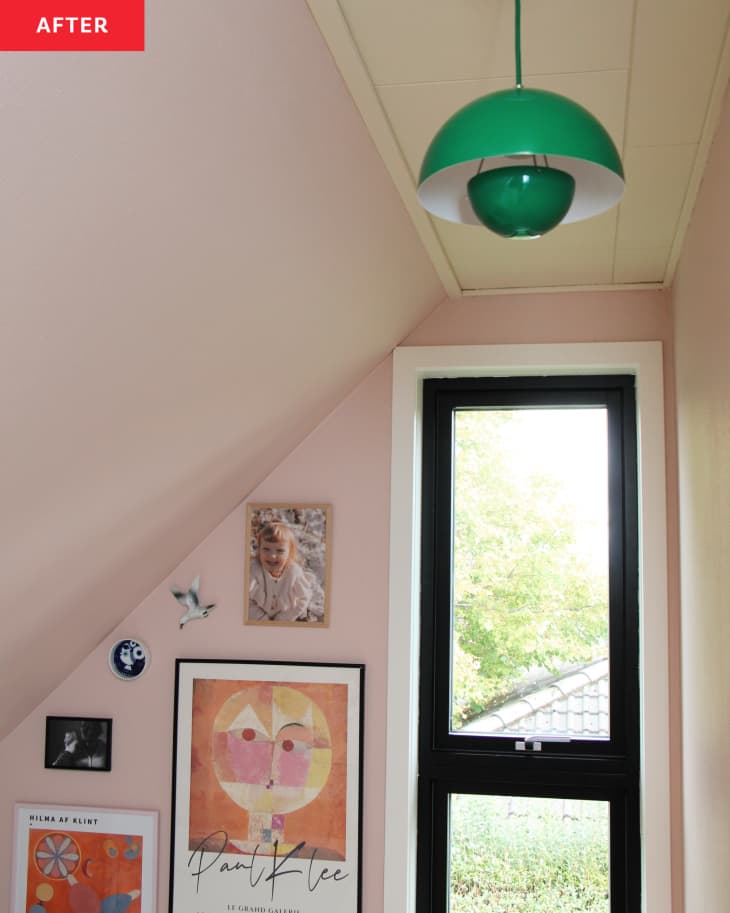 pink walls, angled ceiling, black window frame, white window trim, gallery wall, green half orb lighting fixture