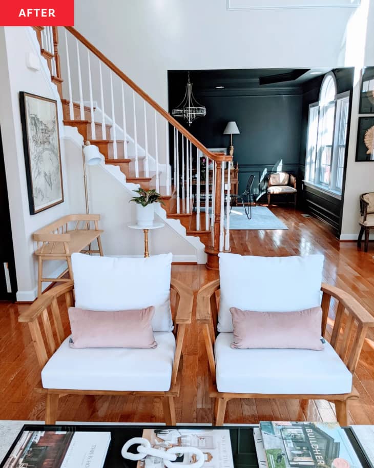 2 white and wood armchairs in front of stairway in remodeled home office