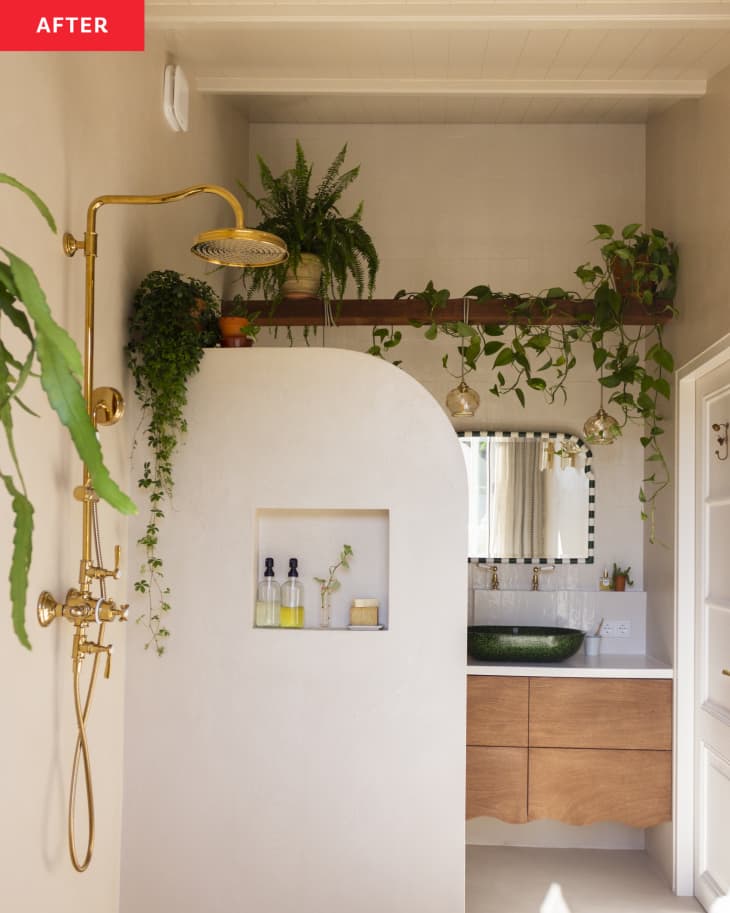 Golden shower hardware in a beige bathroom.