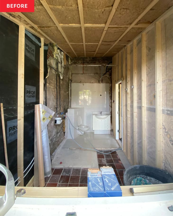 A bathroom with exposed insulation.