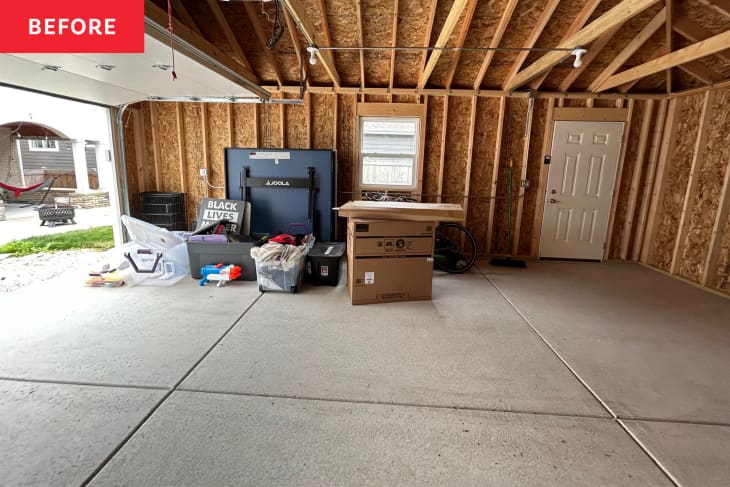 A two-car garage with items around the edges.