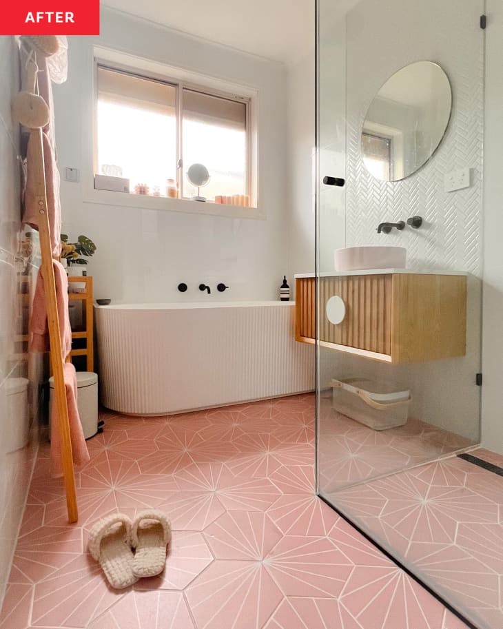 A renovated bathroom with pink tile floor.