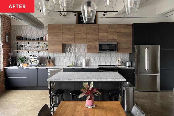 A white kitchen with wooden overhead cabinets and black base cabinets.