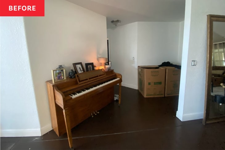 Hallway with piano and a large standing mirror.