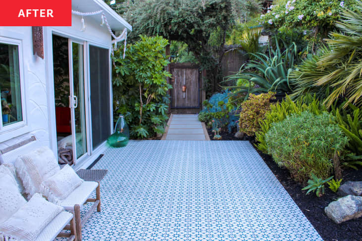 white house with black and white tiled large deck in yard