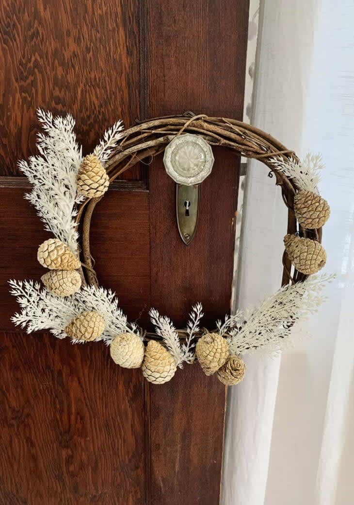 Grapevine wreath decorated with bleached pinecones dried botanicals