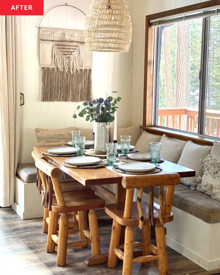 dining table with banquet wall seating and rustic wood chairs, fiber art on wall