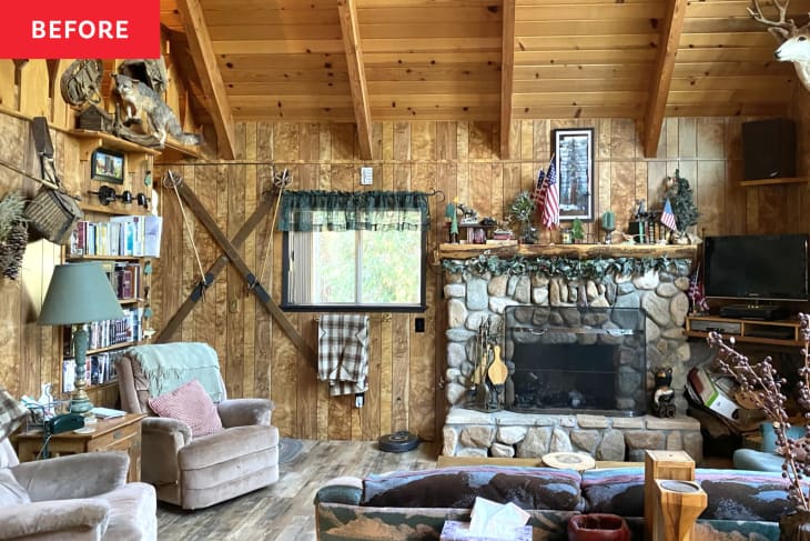 vaulted wood paneled ceiling and stone fireplace with wood paneling on walls and animal furs