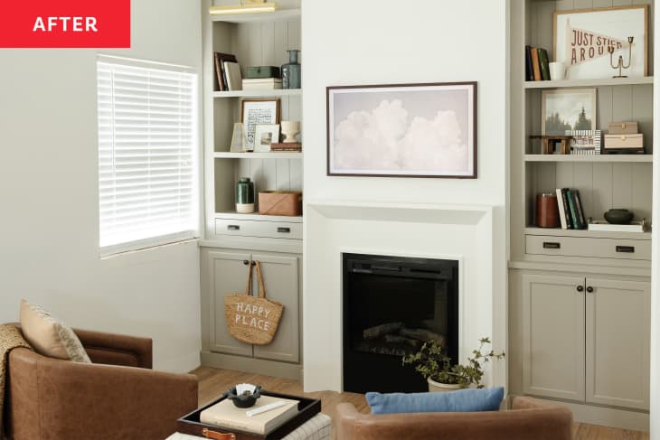 A living area in a gray room with two built-ins flanking a fireplace.