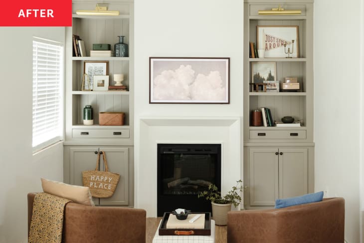 A living area in a white room with two built-ins flanking a fireplace.