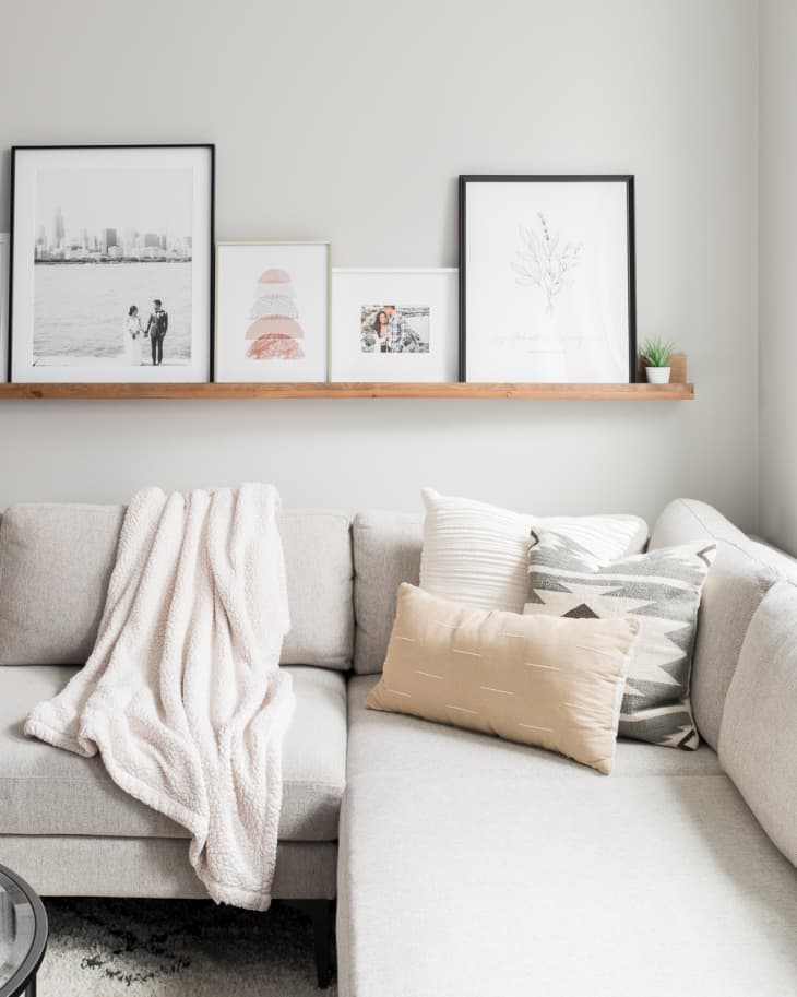 wooden picture shelf above the sofa