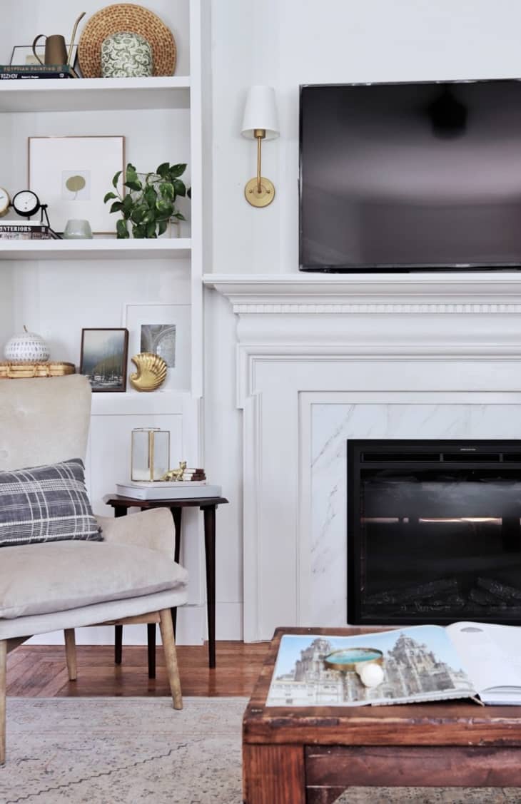 Fireplace with classic surround painted white, and a TV above