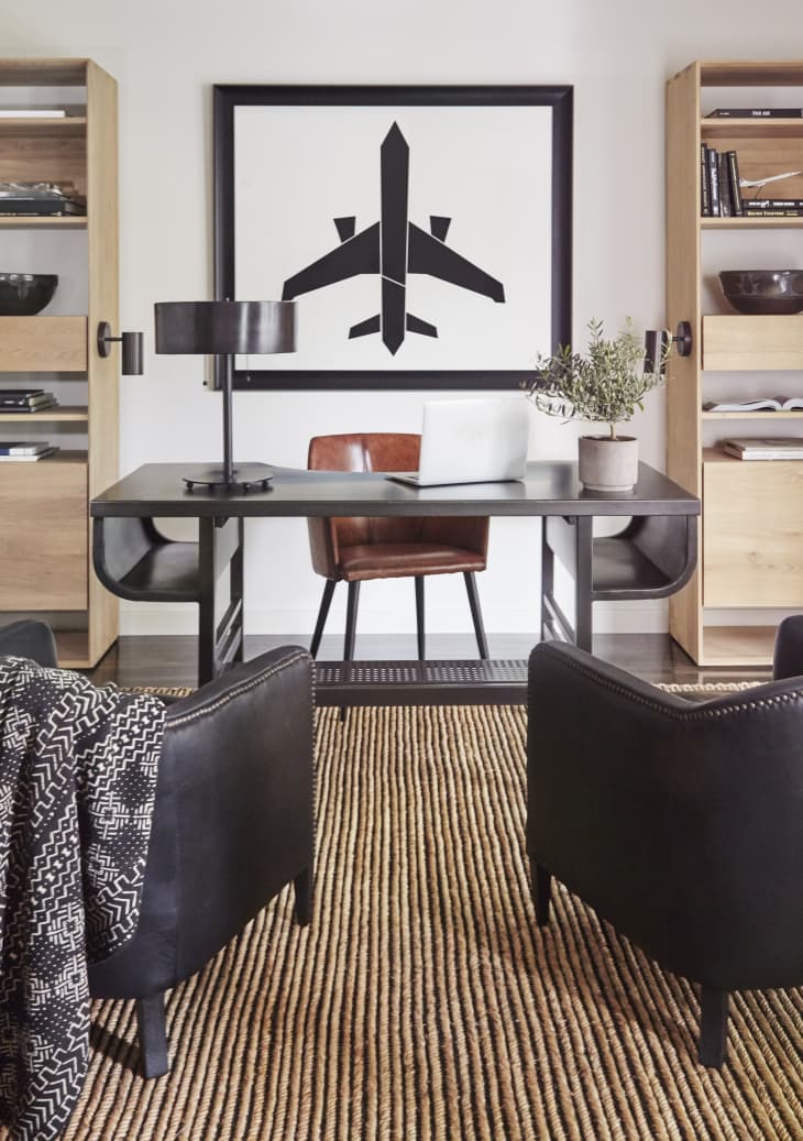 Office with large DIY art print of plane behind desk